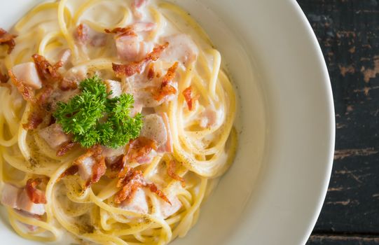 Spaghetti Carbonara with Bacon and Ham and Parsley and Mayonnaise Sauce. Spaghetti Carbonara with Bacon and Ham in mayonnaise cream sauce for food and drink category. 
Spaghetti Carbonara with Bacon breakfast