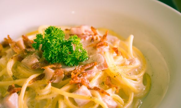 Spaghetti Carbonara with Bacon and Ham and Parsley and Mayonnaise Sauce. Spaghetti Carbonara with Bacon and Ham in mayonnaise cream sauce for food and drink category. 
Spaghetti Carbonara with Bacon breakfast