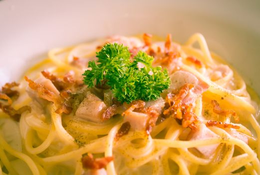 Spaghetti Carbonara with Bacon and Ham and Parsley and Mayonnaise Sauce. Spaghetti Carbonara with Bacon and Ham in mayonnaise cream sauce for food and drink category. 
Spaghetti Carbonara with Bacon breakfast