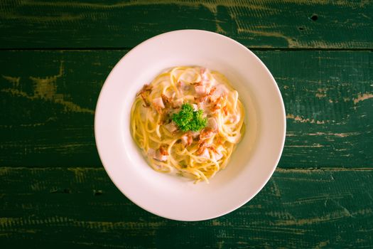 Spaghetti Carbonara with Bacon and Ham and Parsley and Mayonnaise Sauce. Spaghetti Carbonara with Bacon and Ham in mayonnaise cream sauce for food and drink category. 
Spaghetti Carbonara with Bacon breakfast