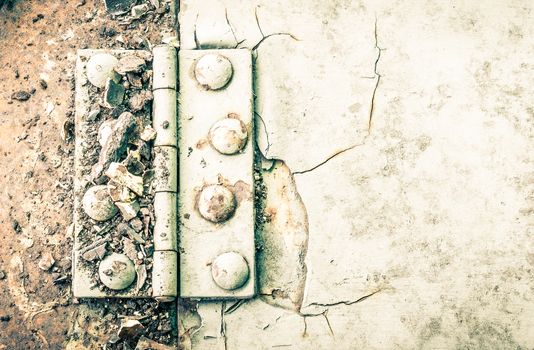 Old metal hinge and rust and rivet on old metal sheet of auto part in high contrast style. Grunge or retro or old background for industry design.