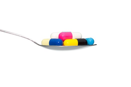 Various color drug or pill or vitamin on metal Spoon isolated on white background. Concept about health care or medical or science including food concept.