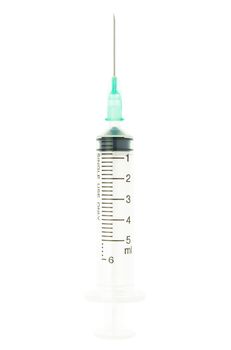 Plastic green syringe isolated on white background on vertical view. Single use medical tool in hospital for injection.