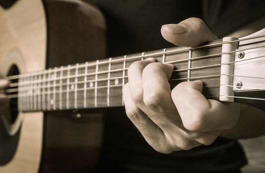 Guitar Player Hand or Musician Hand in C Major Chord on Acoustic Guitar String with soft natural light in side view