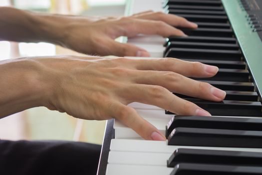 Hand of Piano Player on White Keys and Black Keys of Electric Piano in Zoom View