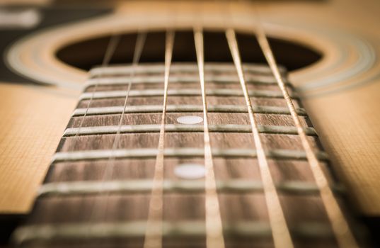 Close Up Fingerboard and Inlay of 6 String Brown Wood Acoustic Guitar