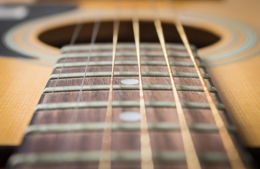 Close Up Fingerboard and Inlay of 6 String Brown Wood Acoustic Guitar