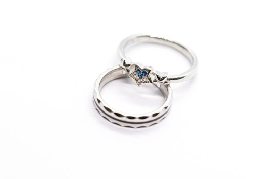 silver ring design with blue stone on white background