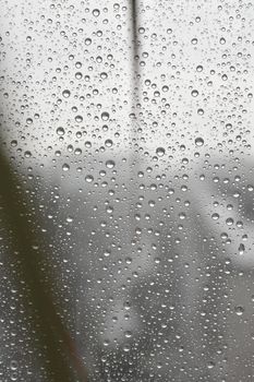 Drops of rain on the window, rainy day. Shallow DOF