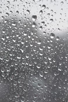 Drops of rain on the window, rainy day. Shallow DOF