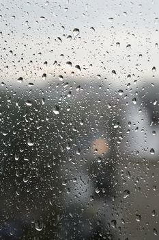 Drops of rain on the window, rainy day. Shallow DOF