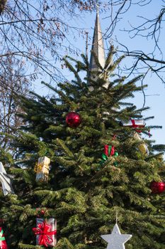 Beautiful christmas tree with gift boxes and shopping bags 