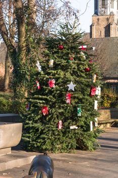 Beautiful christmas tree with gift boxes and shopping bags 