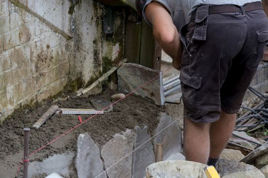 Workers at the laying and clipping of natural stone plates