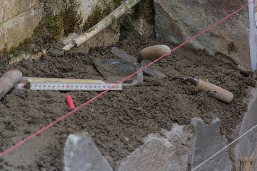 Workers at the laying and clipping of natural stone plates