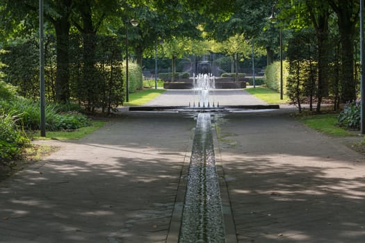 Small weir waterfall fountain in a public park