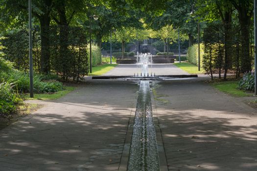 Small weir waterfall fountain in a public park