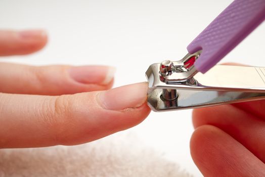 Woman cuts nails with nail cutter.Close-up Homemade manicure