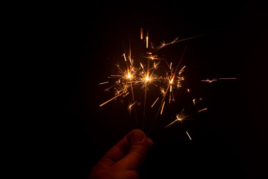 Sparklers shining bright in dark room