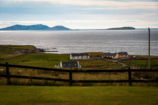 Farmhouses and sheep on the coast of the Irish Sea.