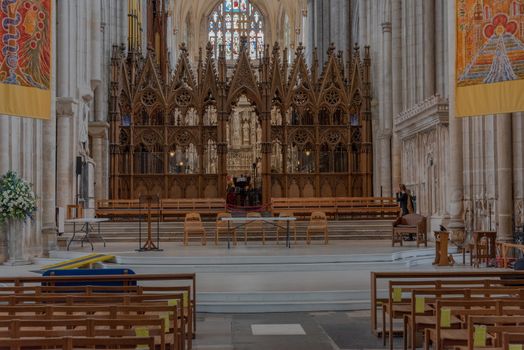 Winchester, England--July 17, 2018. The front altar area in England's famous Winchester Cathedral. Visitors can be seen in the front and to the side.
