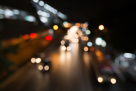 Abstract blurred traffic city of Night market on street light bokeh background. Bangkok, Thailand Cityscape at twilight time concept: focus in Motion blur,  Modern business building estate nightlife.