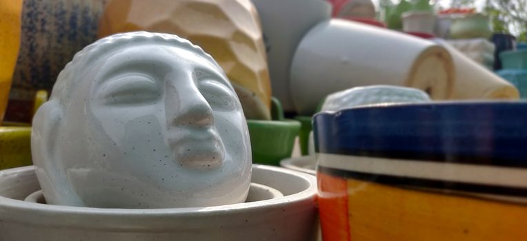 Buddha face as a garden porcelain pot inside a plant nursery in New Delhi, India