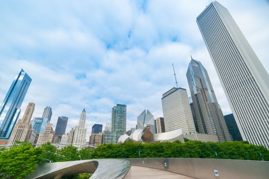 Skating Ribbon leading  through Chicago's Millennium Park, overs-hadowed by the city's high-rise cityscape leaning in on the city below.