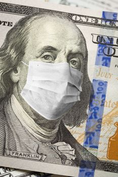 One Hundred Dollar Bill With Medical Face Mask on Face of Benjamin Franklin.