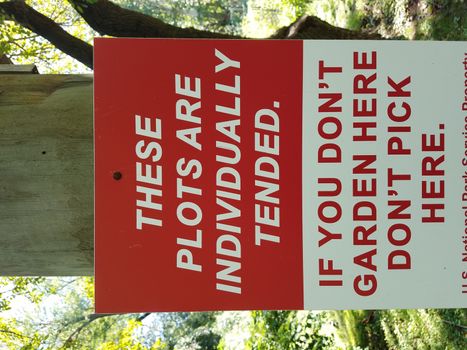 red and white garden plots do not pick here sign
