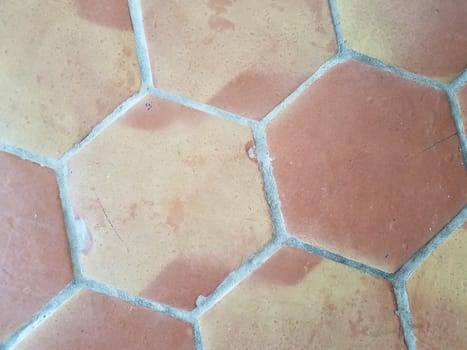 orange and yellow hexagon shape pattern tile floor