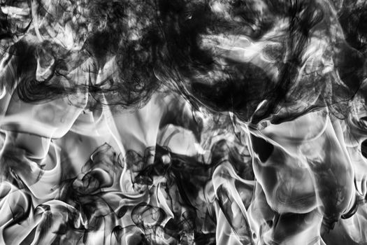 Dramatic Abstract plume of natural black smoke and white huge flame of strong fire, high temperature flames. Motion blur. Dramatic moody black and white image. Dangerous firestorm abstract background