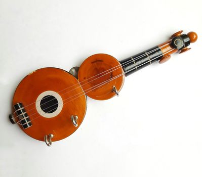 Chennai, India - July 14 2020: Guitar shape Key chain hanger placed beautifully in white background for interior home decorations