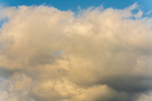 Summer clouds floating across sunny blue sky to change weather. Atmospheric and optical dispersion, soft focus, motion blur clouds. Natural meteorology abstract texture, nature background.