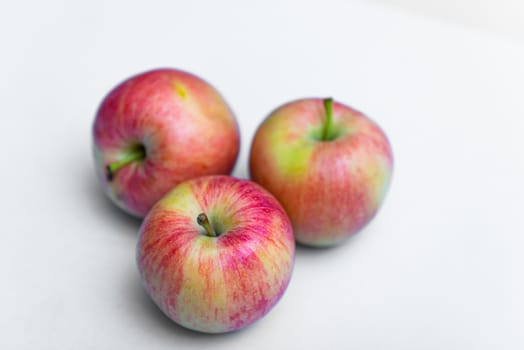 Three rustic apple on a white background