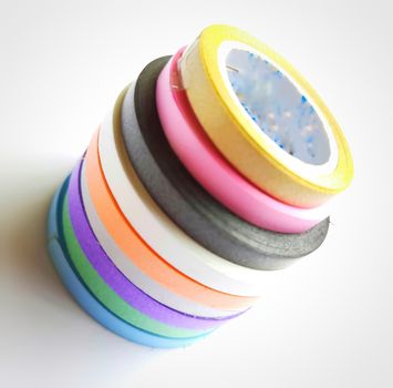 Multi colored curling ribbon arranged in diagonal shape beautifully in white chart as backgrounds