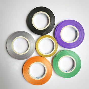 Multi colored curling ribbon arranged in round shape beautifully in white chart as backgrounds