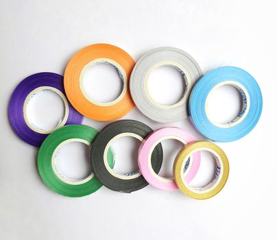 Multi colored curling ribbon arranged in curve shape beautifully in white chart as backgrounds