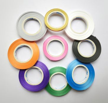 Multi colored curling ribbon arranged in round shape beautifully in white chart as backgrounds