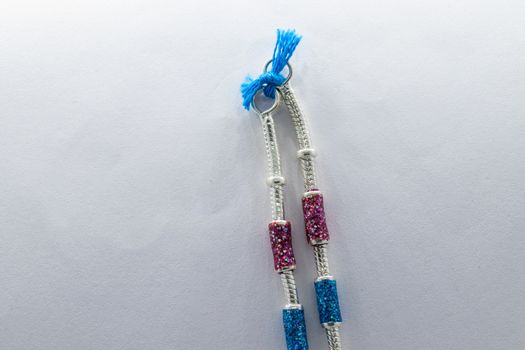 silver leg chain design with red and blue stones on the white background (anklet)