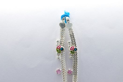 beautiful silver leg chain with flower design on the white background (anklet)