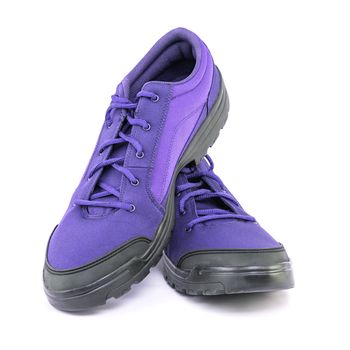 a pair of cheap cheap purple hiking shoes isolated on white background - perspective close-up view.