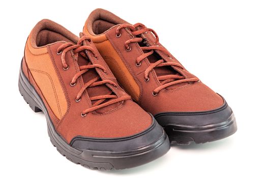 a pair of orange cheap durable fabric travel shoes isolated on white background.