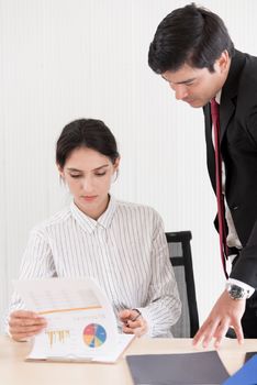 A manager and secretary working together in the office.