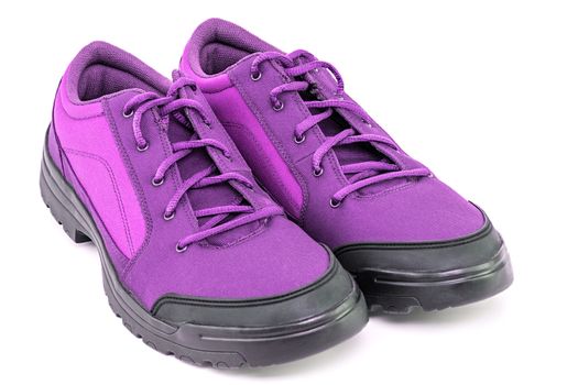 a pair of cheap cheap purple hiking shoes isolated on white background - perspective close-up view.