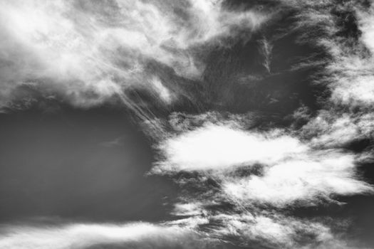 Cloudscape background texture of black and white dramatic monochrome cirrus and cumulus clouds stock photo