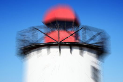 Old 19th century Georgian lighthouse at Burry Port, Carmarthenshire Wales UK with a zoom burst blur effect stock photo