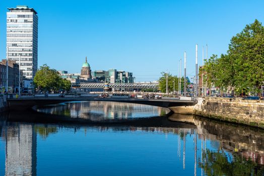 Dublin, Ireland--July 9, 2018. Sunshine and shadows along the banks of the River Liffey.