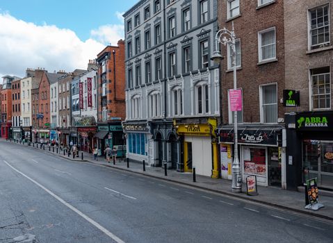 Dublin, Ireland--July 9, 2018. A row of flats, shops and stores in Dublin on a summer morning.