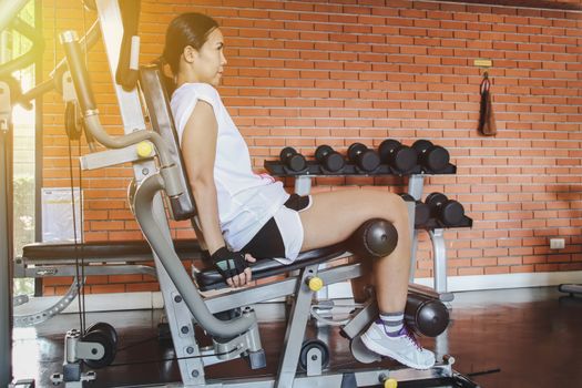 woman exercise workout on machine in gym.Concept of fitness.